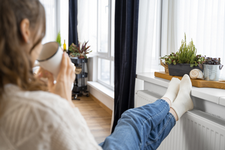 close-up-woman-sitting-near-heater.png